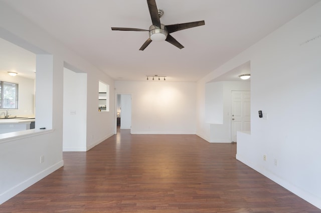 unfurnished room with sink, dark hardwood / wood-style floors, and ceiling fan