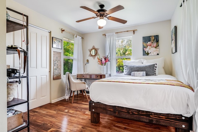19 Hoku Pl, Paia, HI 96779 - bedroom with multiple windows, wood finished floors, a ceiling fan, and baseboards