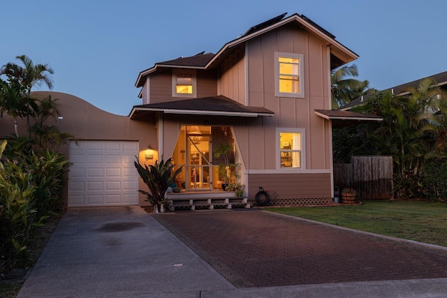 19 Hoku Pl, Paia, HI 96779 - view of front of house with concrete driveway, an attached garage, and board and batten siding