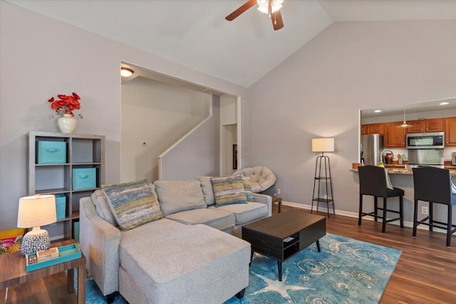 living room featuring ceiling fan, dark hardwood / wood-style flooring, and high vaulted ceiling