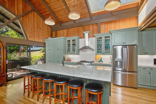 living room featuring high vaulted ceiling, wooden walls, and light hardwood / wood-style floors