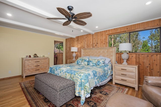 bedroom with wooden walls, baseboards, recessed lighting, beamed ceiling, and light wood-type flooring