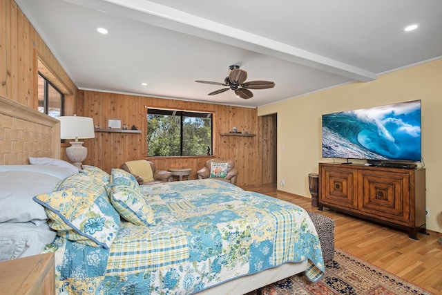 bedroom featuring recessed lighting, beamed ceiling, wood finished floors, and wood walls