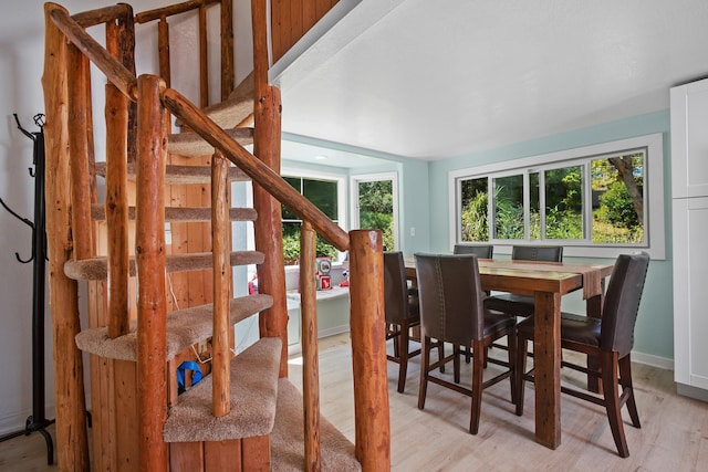 dining room with stairs and light wood-style floors