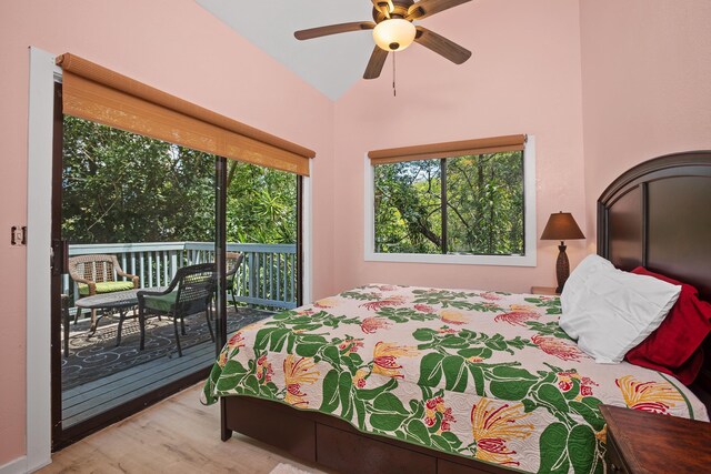 bedroom featuring lofted ceiling, access to outside, and wood finished floors