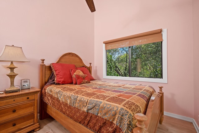 bedroom with a ceiling fan, light wood-style floors, and baseboards