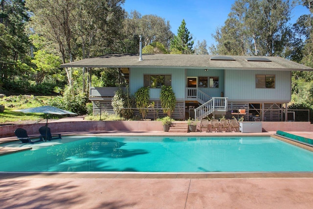 pool with stairs and a patio area