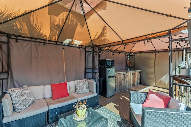 view of patio featuring a gazebo and outdoor lounge area