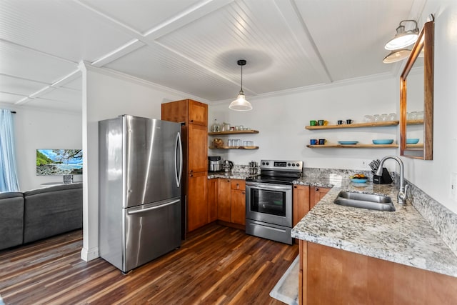 kitchen with light stone counters, dark hardwood / wood-style floors, sink, pendant lighting, and stainless steel appliances