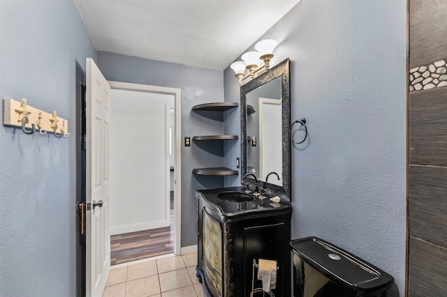 bathroom with vanity, a textured ceiling, and tile patterned flooring