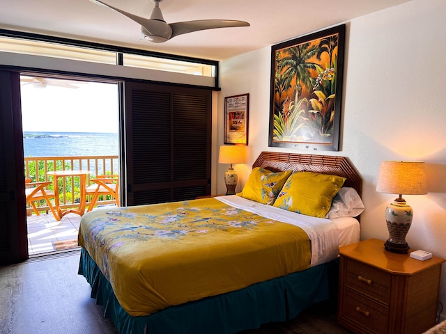 bedroom featuring multiple windows, ceiling fan, a water view, and access to exterior