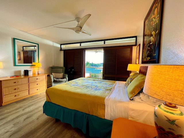 bedroom featuring wood-type flooring, access to outside, and ceiling fan