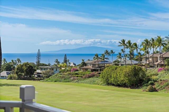 view of home's community featuring a water and mountain view and a yard