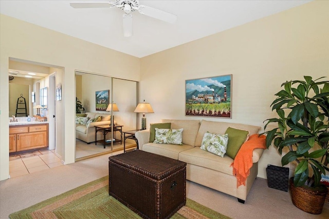 carpeted living room featuring ceiling fan