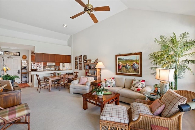 carpeted living room featuring high vaulted ceiling and ceiling fan