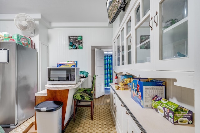 2120 Onaona St, Wailuku, HI 96793 - kitchen featuring appliances with stainless steel finishes, white cabinets, light countertops, and glass insert cabinets
