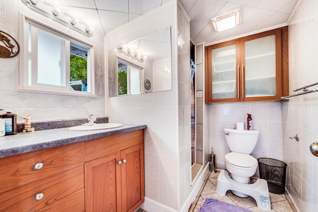 2120 Onaona St, Wailuku, HI 96793 - bathroom featuring tile walls, vanity, toilet, a shower stall, and tile patterned flooring
