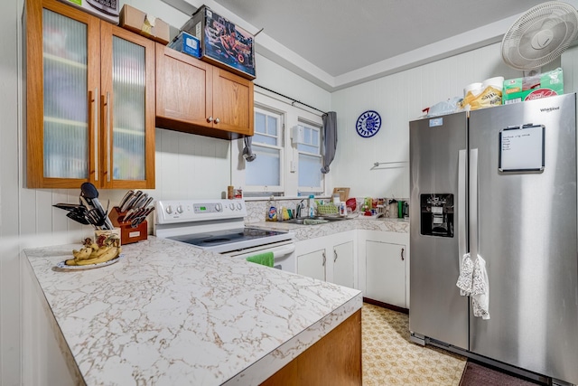 2120 Onaona St, Wailuku, HI 96793 - kitchen featuring stainless steel refrigerator with ice dispenser, electric stove, a sink, light countertops, and glass insert cabinets