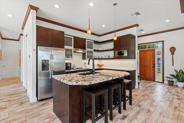 kitchen featuring pendant lighting, sink, built in microwave, stainless steel fridge with ice dispenser, and dark brown cabinets