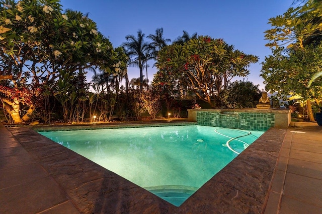 view of pool at dusk