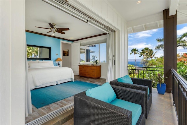 bedroom featuring ceiling fan, access to exterior, and crown molding