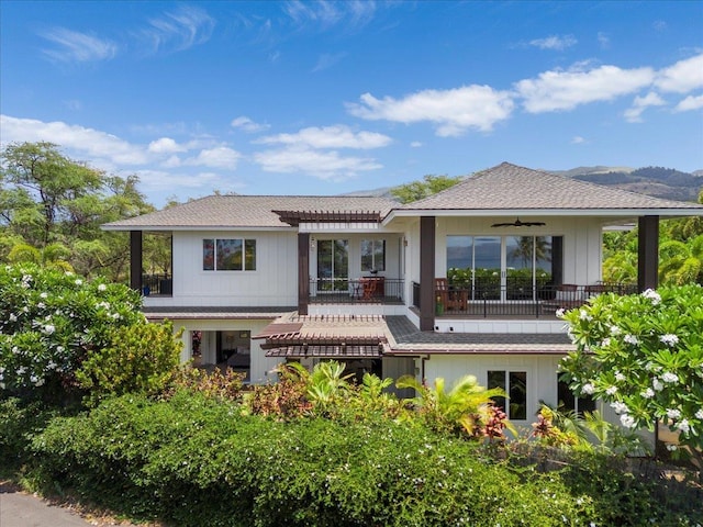 back of property with ceiling fan