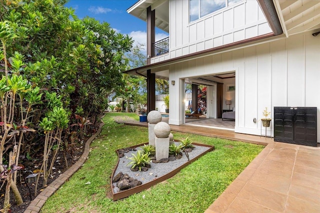 view of yard with a balcony and a patio