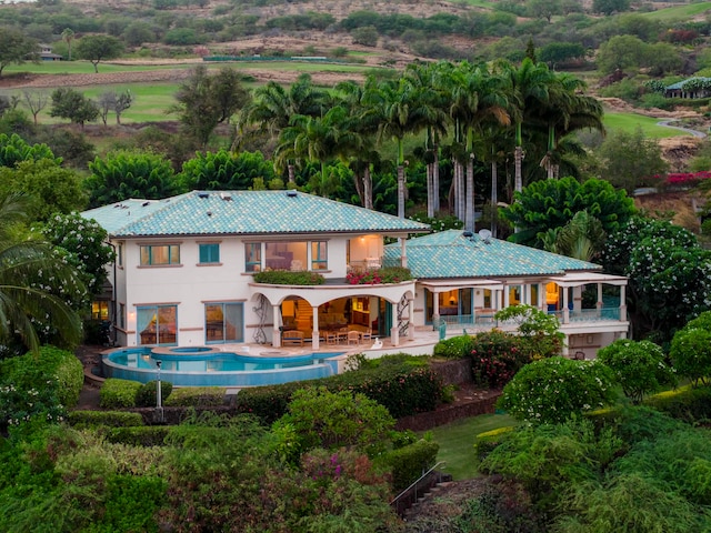 back of property featuring a patio area and a balcony