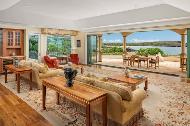 living room with a water view and light hardwood / wood-style floors