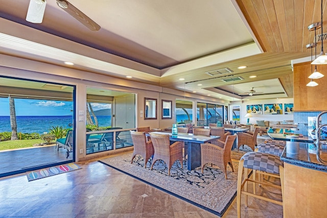 160 Pualei Dr Unit 160-4, Lahaina, HI 96761 - dining space featuring ceiling fan, a raised ceiling, a water view, and recessed lighting
