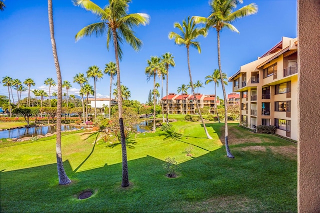 view of property's community featuring a yard and a water view