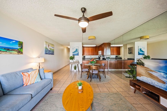 tiled living room featuring ceiling fan and a textured ceiling