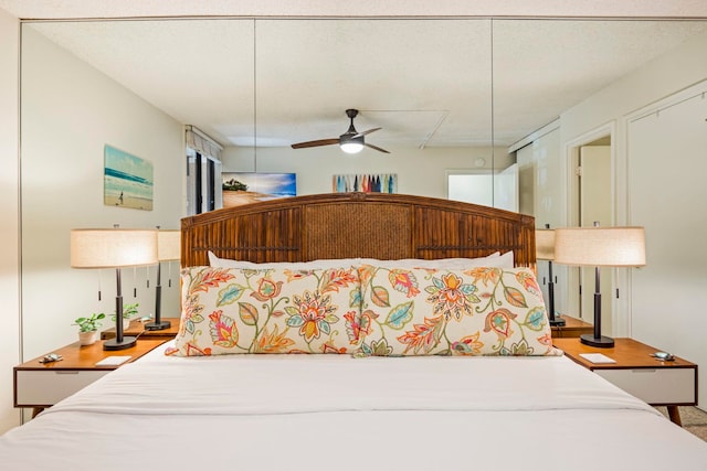 bedroom with a textured ceiling and ceiling fan