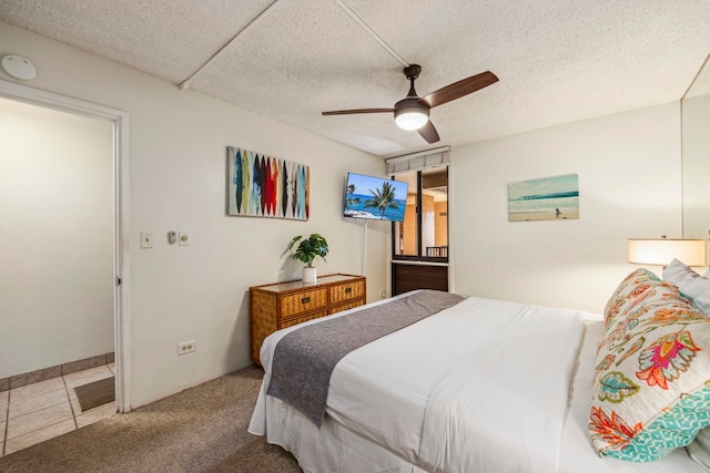 bedroom featuring carpet, ceiling fan, and a textured ceiling