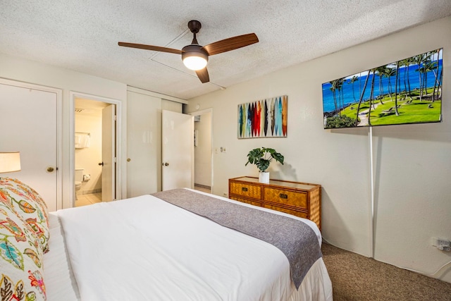 bedroom featuring carpet, ceiling fan, a textured ceiling, and ensuite bath