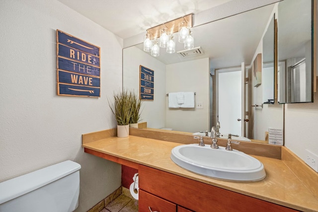 bathroom featuring vanity and toilet