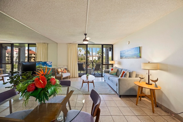 living room with floor to ceiling windows, ceiling fan, light tile patterned floors, and a textured ceiling