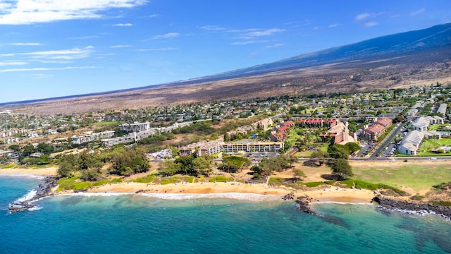 birds eye view of property featuring a water view and a beach view