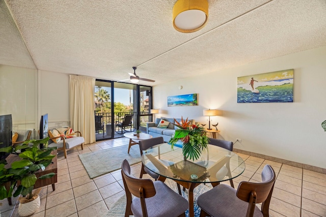 dining area with floor to ceiling windows, ceiling fan, light tile patterned flooring, and a textured ceiling