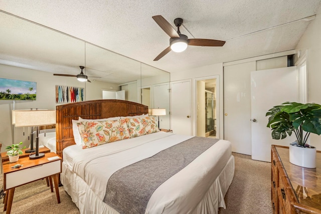 carpeted bedroom featuring ceiling fan and a textured ceiling