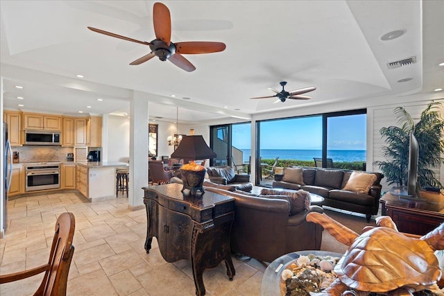 4850 Makena Alanui Rd Unit F-108, Kihei, HI 96753 - living area featuring ceiling fan with notable chandelier, recessed lighting, visible vents, and stone tile floors