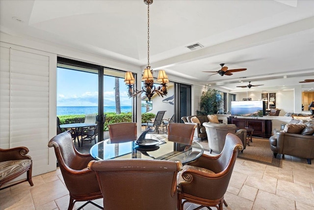 4850 Makena Alanui Rd Unit F-108, Kihei, HI 96753 - dining space with a chandelier, a raised ceiling, visible vents, and stone tile floors