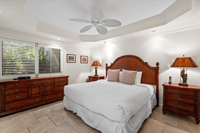 4850 Makena Alanui Rd Unit F-108, Kihei, HI 96753 - bedroom with stone tile floors, a ceiling fan, a raised ceiling, and crown molding