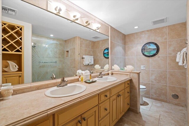 4850 Makena Alanui Rd Unit F-108, Kihei, HI 96753 - bathroom with visible vents, tile walls, and a sink
