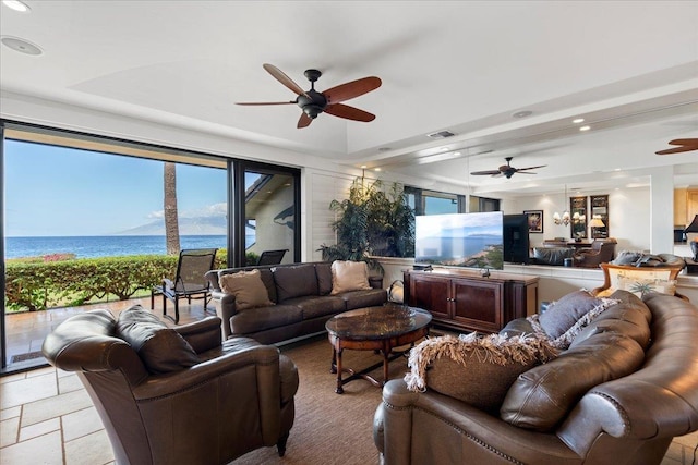 4850 Makena Alanui Rd Unit F-108, Kihei, HI 96753 - living room featuring a tray ceiling, a water view, a ceiling fan, and recessed lighting