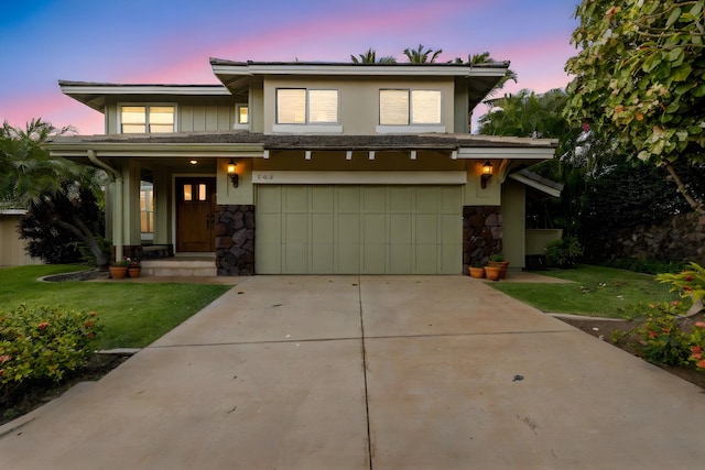 view of front of house with a garage and a lawn