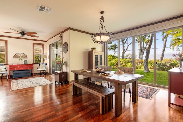 dining space with ceiling fan, wood-type flooring, and crown molding