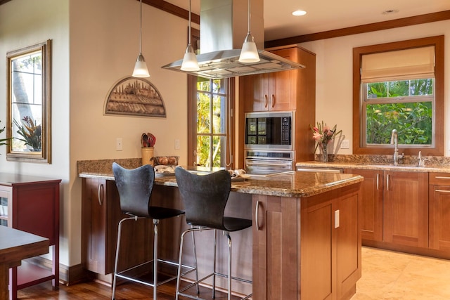 kitchen featuring island range hood, sink, stainless steel oven, and light stone counters