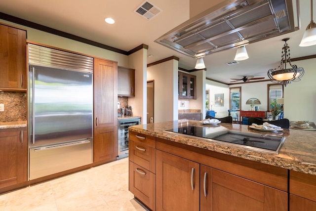 kitchen featuring decorative backsplash, island exhaust hood, stainless steel built in refrigerator, black electric cooktop, and beverage cooler