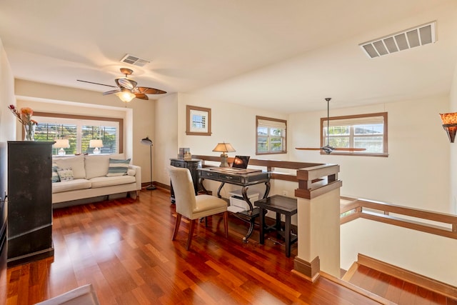 office with dark hardwood / wood-style floors and ceiling fan